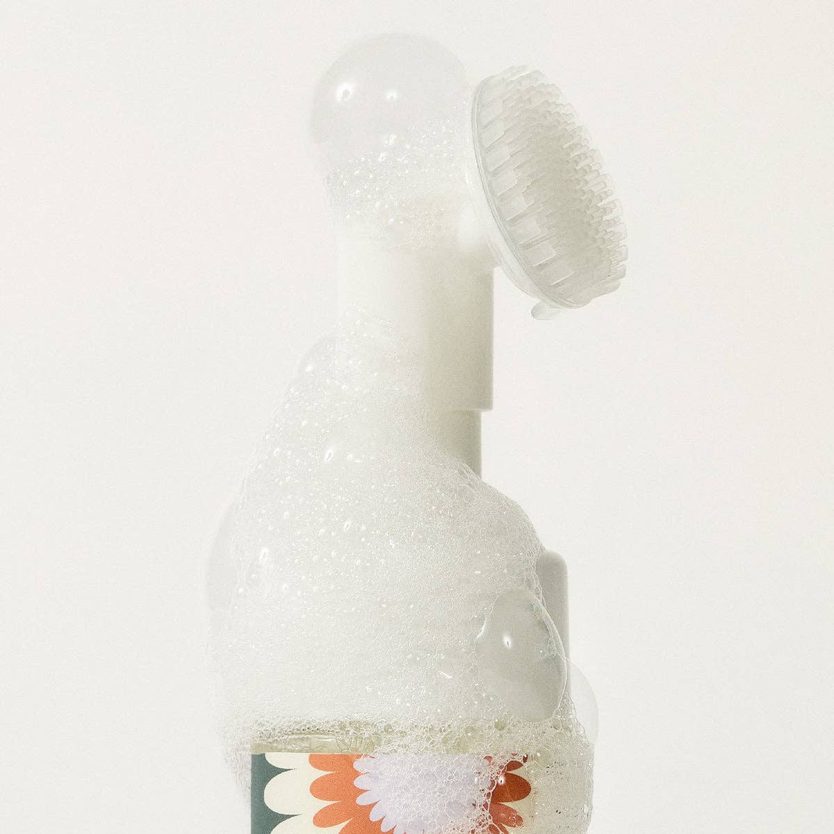 Close-up of Clean Paws foaming cleanser pump with silicone brush