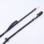 The Tank hands-free dog leash in black, flat lay showing adjustable loop and gold clip
