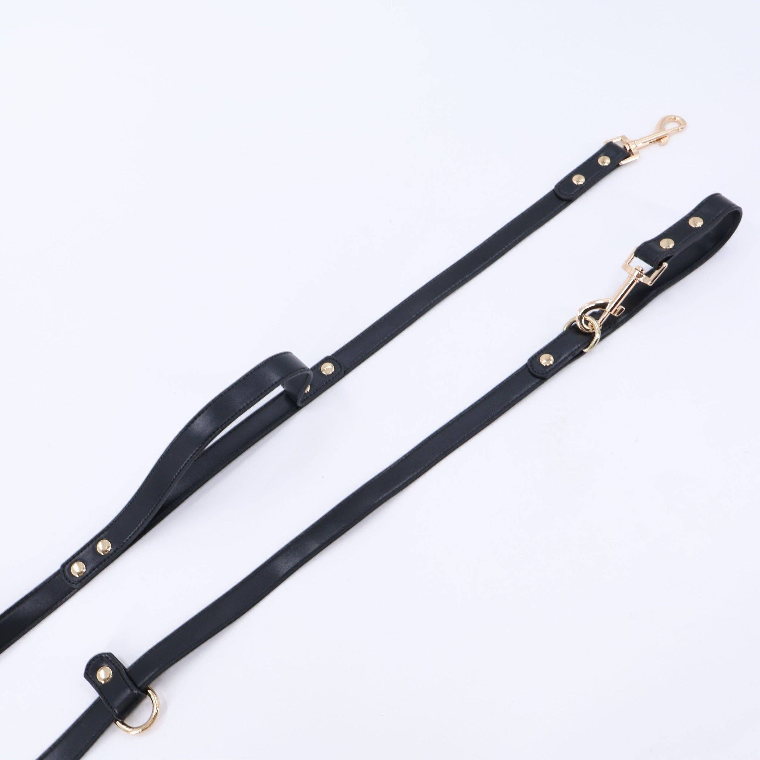 The Tank hands-free dog leash in black, flat lay showing adjustable loop and gold clip